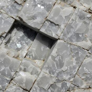 Close up view of fractured gray rock with distinct geometric patterns and subtle variations in texture and shading photo