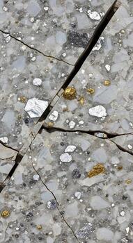 Close up view of a cracked concrete surface with small pebbles and water droplets reflecting light creating a textured abstract pattern photo