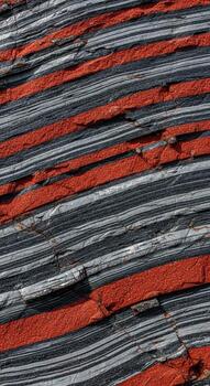 Abstract close up of a woven textile featuring bold diagonal stripes of red gray and white creating a dynamic textured pattern photo