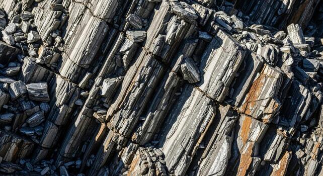 Close up view of weathered columnar basalt rock formations showing distinct vertical columns and varied textures photo