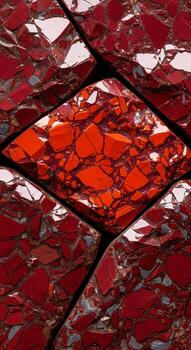 Abstract close up of a textured surface with a central diamond shape filled with vibrant red fragments and surrounding red and white patterns photo