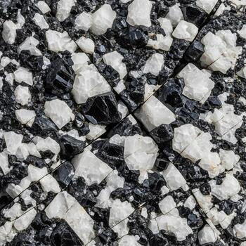 Close up abstract view of a textured surface with irregular white and dark gray fragmented pieces creating a unique pattern photo