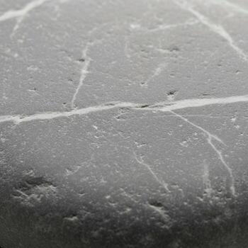 Close up abstract view of a scratched and textured surface showing subtle imperfections and light reflections photo