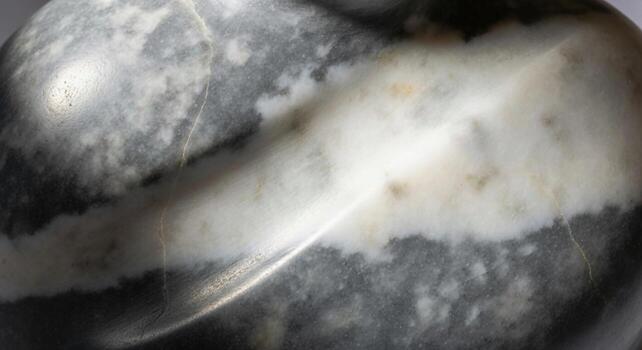 Close up abstract view of a textured surface with swirling light patterns and speckled details photo