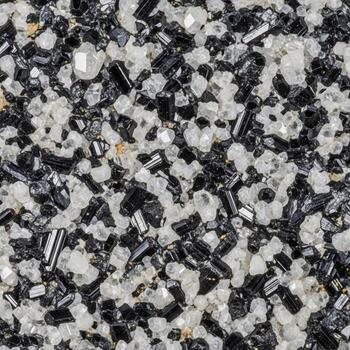 Close up abstract texture of black and white granular material with reflective elements creating a speckled pattern photo