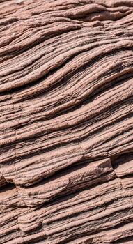 Close up view of weathered reddish brown wood grain with distinct horizontal parallel lines and subtle texture photo