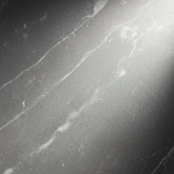 Abstract close up of a textured gray surface with subtle white veining and a bright light source illuminating the upper right corner creating a dramatic effect photo