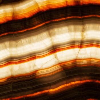 Abstract macro photograph captures the warm glowing layers of translucent onyx stone illuminated from within photo