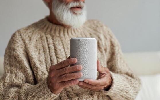 Cozy man in a warm sweater engaging with a voice assistant in a comfortable indoor setting photo