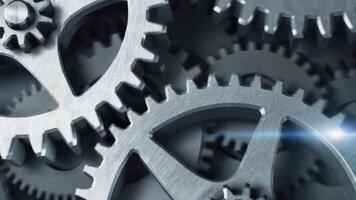 Close up of interlocking metal gears with visible light flare mechanical machinery concept textures patterns background video