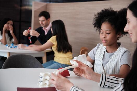 Group of students brainstorm and discuss with their teachers' tables in science lesson, playful learning in primary class together, studying kids' knowledge at elementary international school. photo