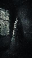 Ghostly Figure in Tattered Veil Standing in Dark Decayed Room with Dim Light Entering Through Single Window, Animation Made of Cubes video