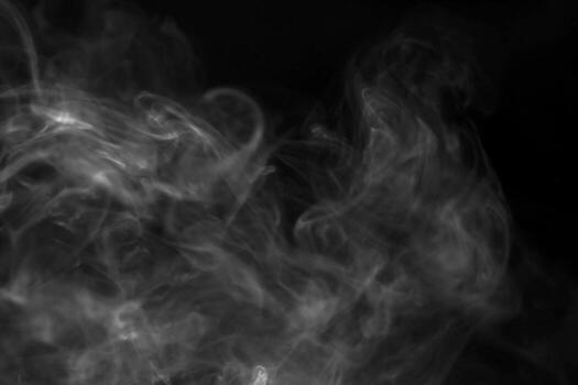 Ethereal Swirls of Smoke on a Dark Background Creating a Mysterious and Atmospheric Abstract Design photo