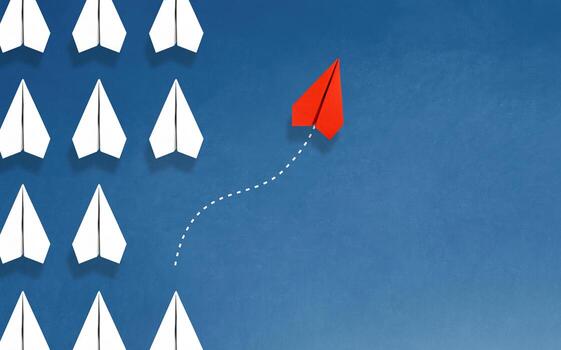 Group of white paper plane in one direction and one red paper plane pointing in different way on blue background. Business for innovative solution concept. photo