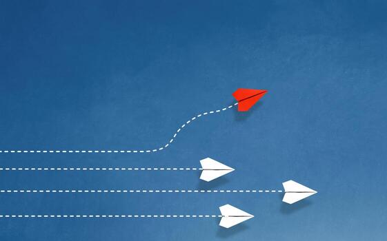 Group of paper ship in one direction and with one individual pointing in the different way. Business concept for innovative solution. photo