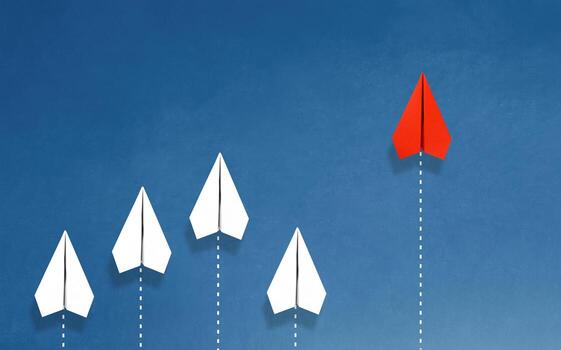 Group of paper plane in one direction and with one individual pointing in the different way on blue background. Business for innovative solution concept. photo