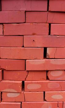 Pattern of Construction Bricks in a Stack with Cracks Detailed Stock Photo. Construction Material Vertical Background photo