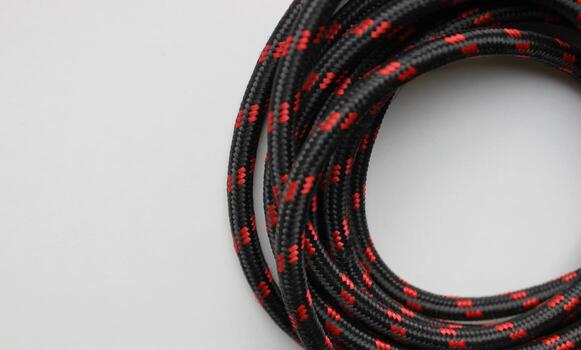 Wire wrapped in silk and twisted into a loop isolated on white flat lay. Silk wire wound in circle form with empty space photo