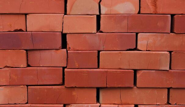 Red bricks stacked on a pallet crack under their own weight. Rows of clay bricks in a stack stock photo for construction background