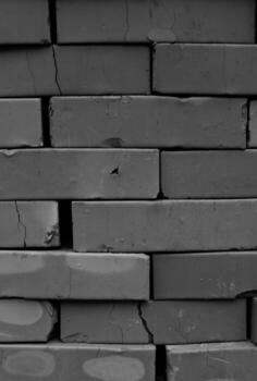 Pattern of Cracked Clay Bricks in a Pile Grayscale Vertical Image. Structure of Stacked Bricks Monochrome Photo