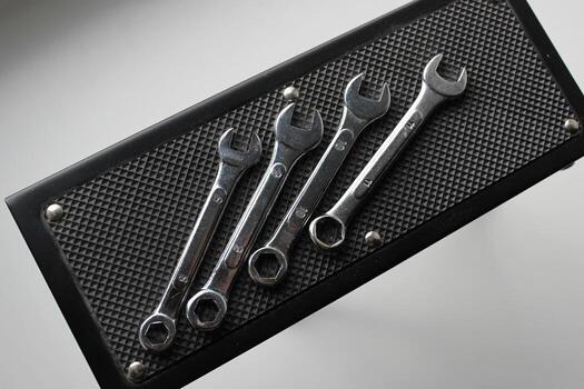 Rubberized stand to prevent working tools from slipping. Open end spanners on a rubber surface flat lay photo