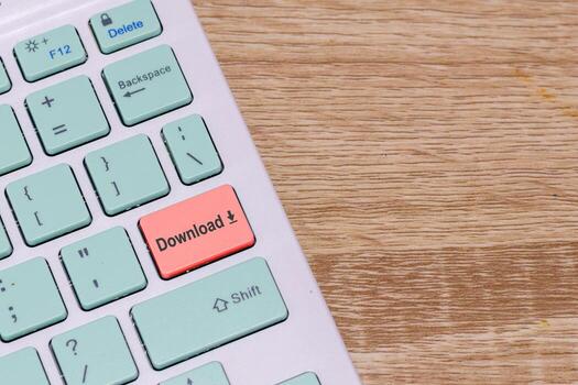 Wireless keyboard with Download button. Keyboard with red download button key. Copy space. photo