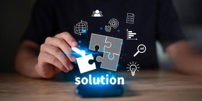 Hand holding a puzzle piece with the word solution and digital icons, symbolizing business problem solving, innovation, teamwork, strategic planning, and finding effective solutions for success photo