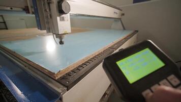 Operator Adjusting CNC Interface During Cutting Process video