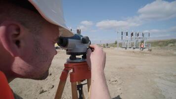 Engineer Calibrating Leveling Tool on Tripod Stand video