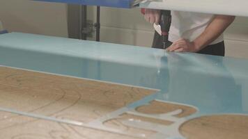 Technician Holding CNC Controller While Machine Operates video