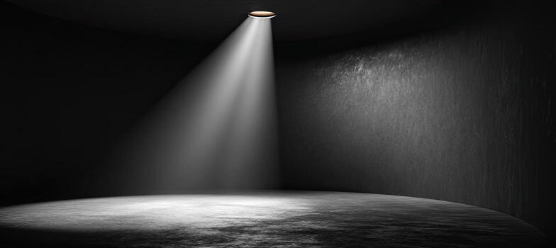 A spotlight shines on a dark room with a floor photo