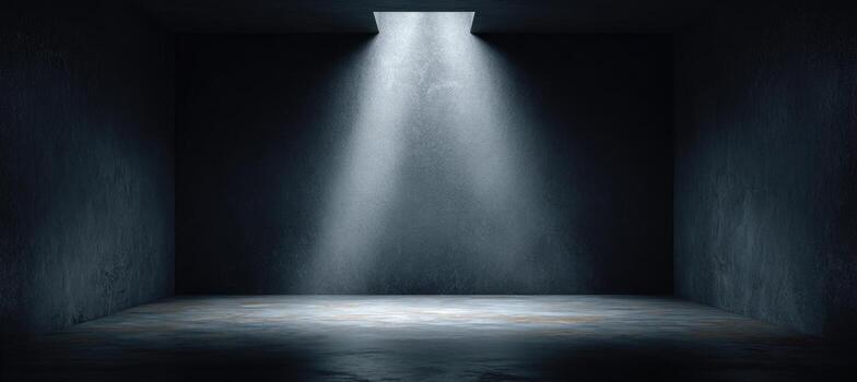 An empty room with a light coming from the ceiling photo