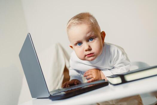 Curious Baby Exploring Technology An Adorable Infant Deeply Engaged with a Laptop in a Modern Setting, Showcasing the Intersection of Play and Learning in Todays Digital Environment photo