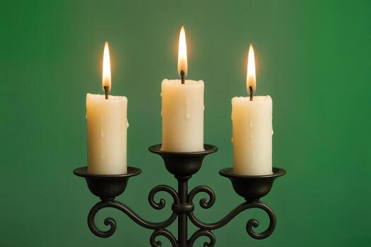Candles Arranged on an Ornate Metal Candelabra Set Against a Green Background With Warm Light From the Flames Creating a Cozy Atmosphere photo