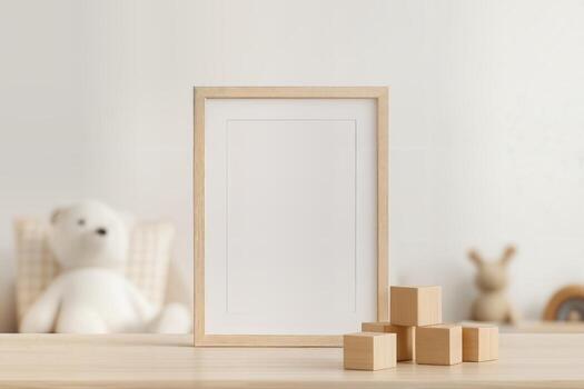 Cozy Kids Room Featuring a Framed Picture with Blank Space on a Wooden Table, Surrounded by Wooden Blocks with Toys Blurred in the Background photo