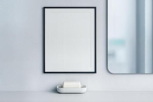 Minimal Bathroom Design Featuring a Simple Wall Mounted Mirror Next to a Framed Print and a Soap Dish on a Clean Surface with a Bright Aesthetic photo