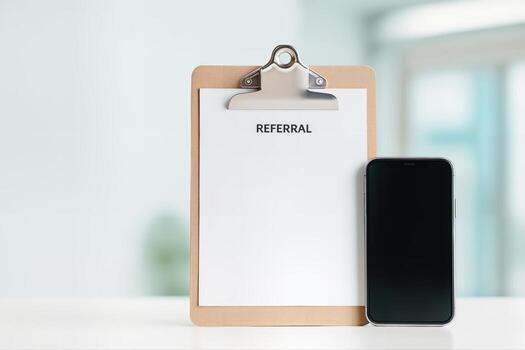 Healthcare Transition Concept with a Referral Clipboard and Smartphone on a Table in a Minimalist Office Setting with Natural Light photo