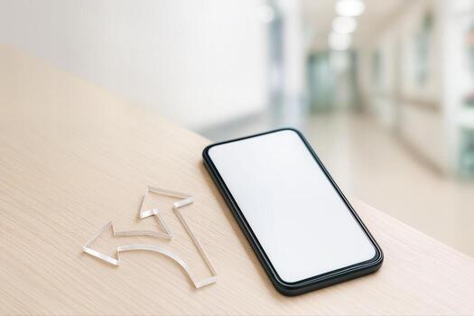 A Smartphone On A Wooden Desk Next To Clear Acrylic Arrows Symbolizing A Fork In The Path In A Bright Office Environment photo