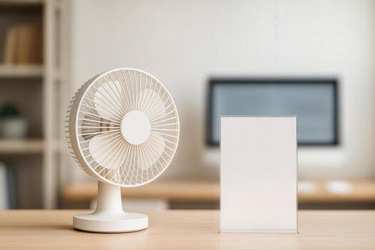 Modern Office Workspace Featuring A Desk Fan And Blank Acrylic Sign On A Wooden Table With A Blurred Background Creating A Minimalist And Summer Vibe photo