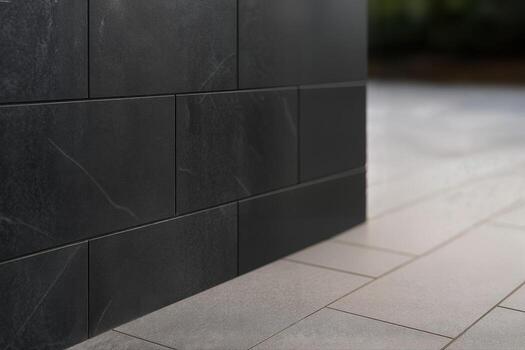 Black Basalt Exterior Wall Closeup Featuring Smooth Textured Tiles Set Against A Light Stone Floor With Natural Light Creating A Minimalist Aesthetic photo