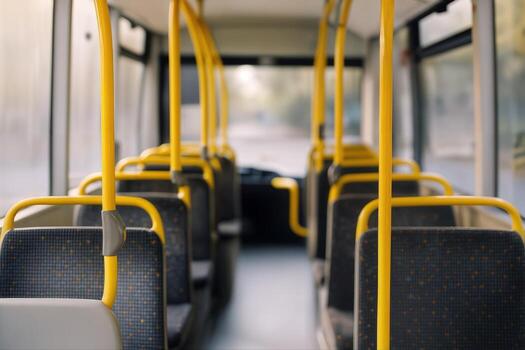Empty City Bus Interior With Yellow Railings and Gray Seats in Soft Natural Light and Subtle Blur to the Background With Shallow Depth Of Field photo