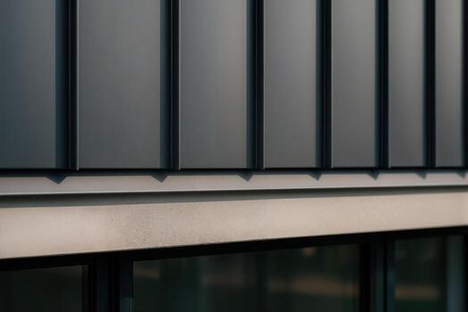 Modern Architectural Facade Featuring Geometric Patterns and Sleek Lines in an Urban Setting on a Clear Day With Subtle Light Reflections photo