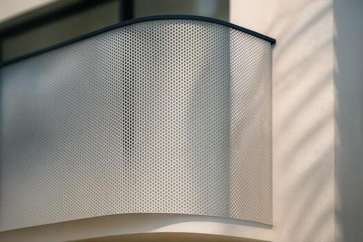 Balcony With Moire Shadow Effect From Sunlight Creating Geometric Patterns On A Metal Railing In An Outdoor Urban Setting photo