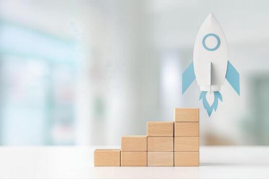 Paper Rocket Launching Indoors Over Wooden Block Stairs Symbolizing Growth and Success With Shallow Depth Of Field in a Brightly Lit Room photo