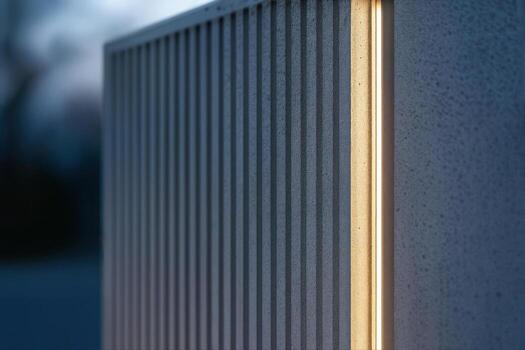 Reeded Concrete Wall Illuminated at Dusk in a Low Light Setting Highlighting Vertical Lines and Texture With Shallow Depth Of Field photo