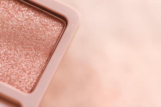Rose Gold Glitter Eyeshadow Closeup With Shimmering Texture And Soft Bokeh Effect On A Blurred Background Providing Elegant And Luxurious Appeal. photo