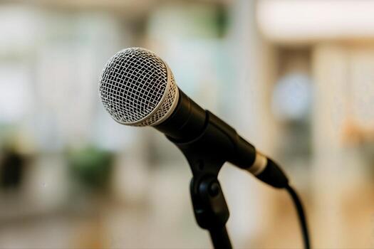 Microphone on Stand Under Spotlight in Indoor Setting with Blurred Background Creating Focus on the Mic for Performance or Speech photo