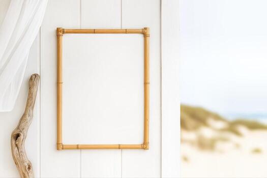 Beachside Setting Featuring A Blank Bamboo Frame On A Light Wooden Wall With Soft Coastal Sand Dunes And Ocean Blurred In The Background photo