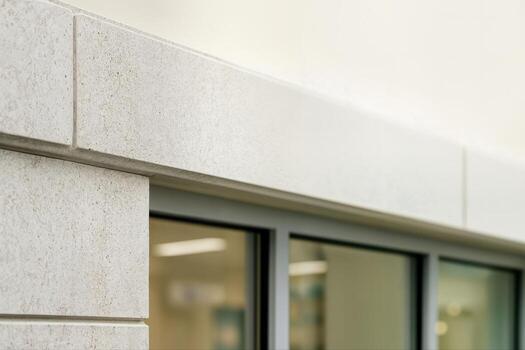 Architectural Stone Details on Building Facade Captured in Closeup Within a Modern Urban Setting Showcasing Elegance and Craftsmanship of Construction Materials photo
