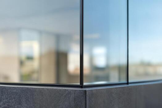 Capless Corner Glazing in Modern Architecture Featuring Glass Panels and Minimalist Design with Reflections in Daylight and a Blurred Background photo